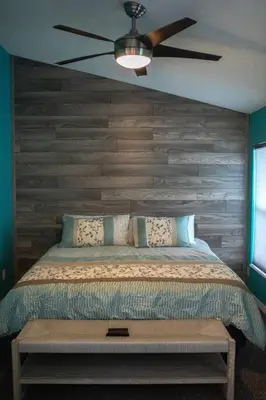 a bedroom with a bed with a ceiling fan at Luxury Disney Family Villa (5-Bedroom, pool & spa) in Kissimmee
