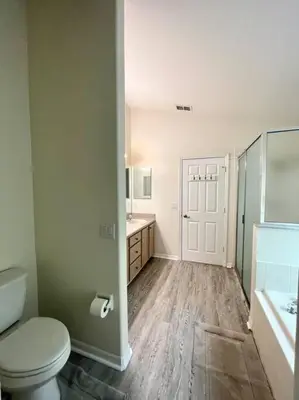 a bathroom with a toilet and a sink and a shower at Luxury Disney Family Villa (5-Bedroom, pool & spa) in Kissimmee