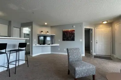 a living room with a kitchen and a table and chairs at very Nice 2/2 apartment , close to disney in Kissimmee