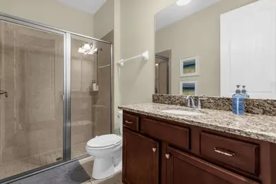 a bathroom with a shower and a toilet and a sink at 7601-IBRAHIM · 7601 Themed 7BD Villa- Poolspa - Game room in Orlando