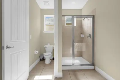 a bathroom with a shower and a toilet at 7601-IBRAHIM · 7601 Themed 7BD Villa- Poolspa - Game room in Orlando