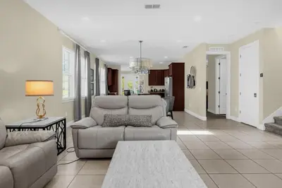 a living room with a couch and a table at 7601-IBRAHIM · 7601 Themed 7BD Villa- Poolspa - Game room in Orlando
