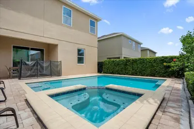 a swimming pool in the backyard of a house at GREAT HOUSE Near Disney, Private Pool in Orlando