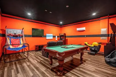 a room with a pool table and a tv at GREAT HOUSE Near Disney, Private Pool in Orlando