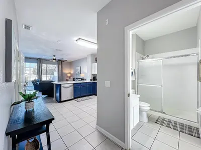 a bathroom with a shower and a toilet in a room at Private Pool Disney Townhome - Walk to Water Park in Orlando