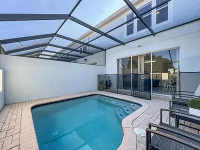 an indoor swimming pool with a roof at Private Pool Disney Townhome - Walk to Water Park in Orlando