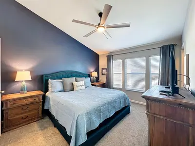 a bedroom with a bed and a ceiling fan at Private Pool Disney Townhome - Walk to Water Park in Orlando