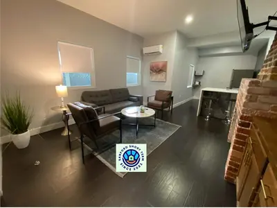 a living room with a couch and a table at The Front Porch in Sanford