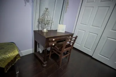 a wooden desk with a chair next to a door at Boho Nights in Sanford