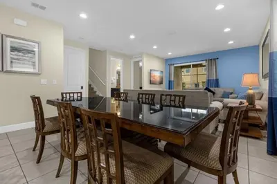 a dining room and living room with a table and chairs at 431 Villa - Spacious 7BD - Screened PoolSPA in Orlando