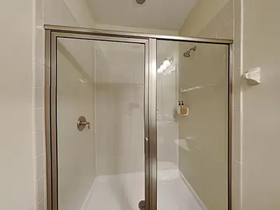 a shower with a glass door in a bathroom at 561 - 8BD Villa - Private PoolSpa by Disney in Orlando