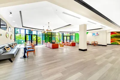an office lobby with a couch and tables and chairs at Stylish 3BR Suite with Swimming Pool - Near Disney in Orlando