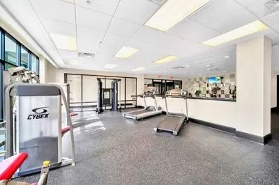 a gym with treadmills and machines in a building at Stylish 3BR Suite with Swimming Pool - Near Disney in Orlando