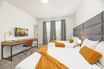a hotel room with two beds and a desk at Luxury home, private pool, themed bedrooms, prime location in Kissimmee