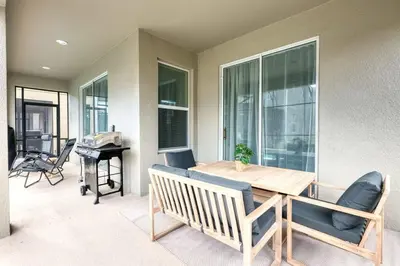 a dining room with a table and chairs and a piano at Luxury home, private pool, themed bedrooms, prime location in Kissimmee