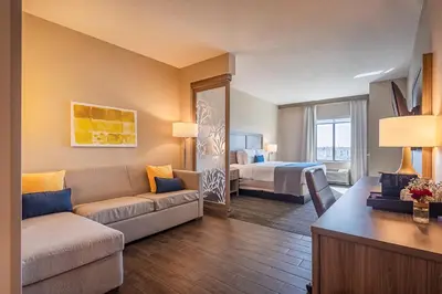 a living room with a couch and a bed at Pestana Orlando Suites - Lake Buena Vista in Orlando