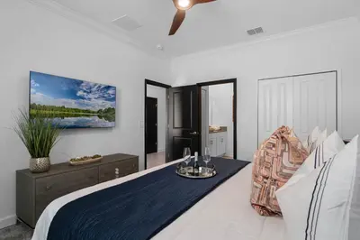 a bedroom with a bed and a ceiling fan at Disney Dream Vacation Home by Disney in Kissimmee