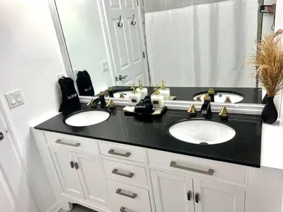 a bathroom with two sinks and a large mirror at Dreamy Family Pool House in Clermont