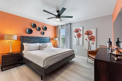 a bedroom with a bed and a ceiling fan at Water Kingdom Storey Lake By Shine Villas #525 in Kissimmee