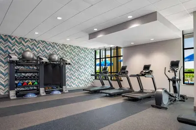 a gym with treadmills and cardio equipment in a room at Hilton Garden Inn Orlando I-4 Millenia Blvd Mall in Orlando
