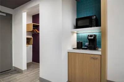 a kitchen with a microwave and a coffee maker on a counter at Hilton Garden Inn Orlando I-4 Millenia Blvd Mall in Orlando