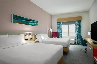 a hotel room with two beds and a television at Hilton Garden Inn Orlando I-4 Millenia Blvd Mall in Orlando