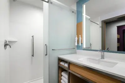 a bathroom with a sink and a mirror at Hilton Garden Inn Orlando I-4 Millenia Blvd Mall in Orlando