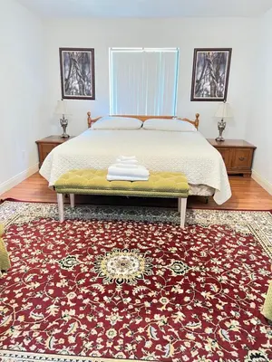 a bedroom with a bed and a red rug at Spacious and relaxing Home - Longwood, Florida in Orlando