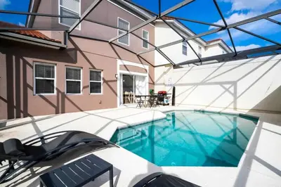 an indoor swimming pool in front of a building at Four Bedroom w/ Screened Pool Close to Disney 4572 in Kissimmee