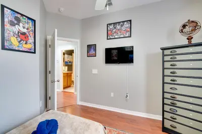 a bedroom with a bed and a dresser at 15 Mi to Disney Kissimmee Townhome with Patio in Kissimmee