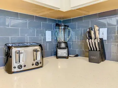 a kitchen counter with a blender and a toaster at Wonderful 2BR Condo with 2 Clubhouses in Kissimmee
