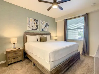 a bedroom with a large bed and a window at Wonderful 2BR Condo with 2 Clubhouses in Kissimmee