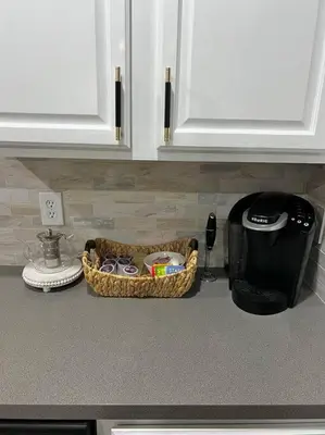 a kitchen counter with a basket on the counter top at Emerald Island Private Pool Home near Disney in Kissimmee