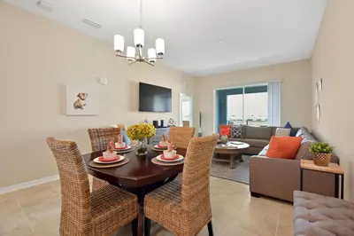 a dining room and living room with a table and chairs at 3131 Paradox Circle, Unit 404 #838 apts in Kissimmee