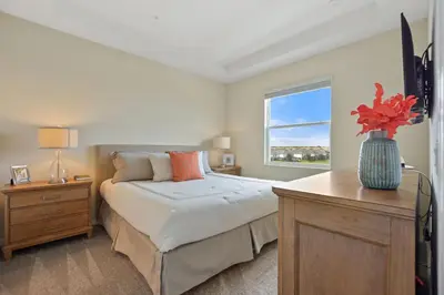 a bedroom with a bed and a vase of flowers on a table at 3131 Paradox Circle, Unit 404 #838 apts in Kissimmee