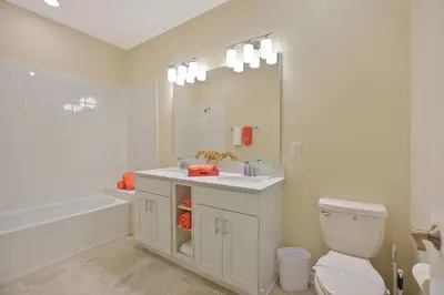 a bathroom with a sink and a toilet and a tub at 3131 Paradox Circle, Unit 404 #838 apts in Kissimmee