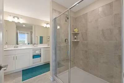a bathroom with a shower and a glass shower stall at Resort Life at Storey Lake by Shine Villas, #702 apts in Kissimmee
