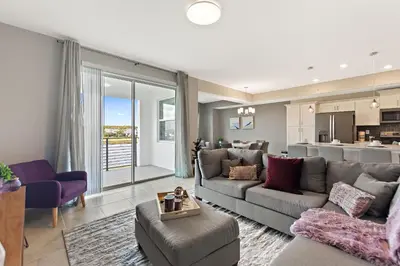 a living room with a couch and a kitchen at Sweet Suite Sleeps 6 Storey Lake by Shine Villas apts in Kissimmee