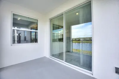 an empty room with glass windows in a building at Sweet Suite Sleeps 6 Storey Lake by Shine Villas apts in Kissimmee