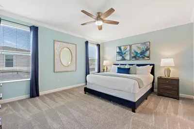 a bedroom with a bed and a ceiling fan at Stars Align Storey Lake by Shine Villas villa in Kissimmee