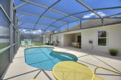an indoor swimming pool with a glass roof at Gilded Parasol by Shine Villas Remington Golf #410 home in Kissimmee