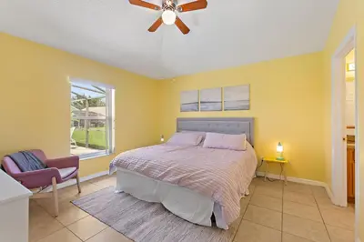 a bedroom with a bed and a ceiling fan at Gilded Parasol by Shine Villas Remington Golf #410 home in Kissimmee