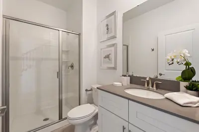a bathroom with a shower and a toilet and a sink at Blue Beach at Storey Lake by Shine Villas #400 townhouse in Kissimmee