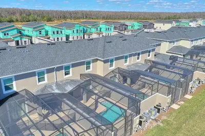 an overhead view of a building with a swimming pool at Blue Beach at Storey Lake by Shine Villas #400 townhouse in Kissimmee