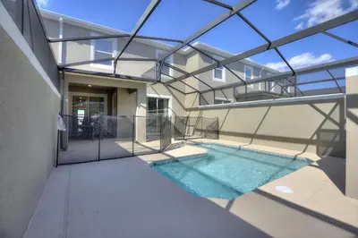 a house with a swimming pool with a glass ceiling at Blue Beach at Storey Lake by Shine Villas #400 townhouse in Kissimmee