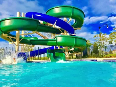 a water slide in a pool at a water park at Blue Beach at Storey Lake by Shine Villas #400 townhouse in Kissimmee
