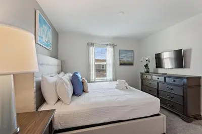 a bedroom with a bed with a dresser and a window at Blue Beach at Storey Lake by Shine Villas #400 townhouse in Kissimmee