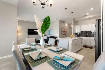 a kitchen and dining room with a table and chairs at Fireworks Night -Storey Lake by Shine Villas 709 apts in Kissimmee