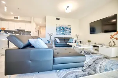 a living room with a blue leather couch at Vacation Meadows - Storey Lake by Shine Villas 710 apts in Kissimmee