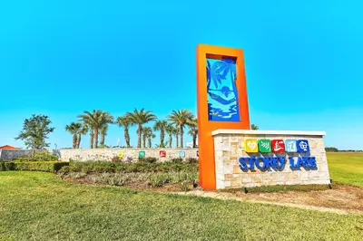 a sign for a water park with palm trees in the background at Vacation Meadows - Storey Lake by Shine Villas 710 apts in Kissimmee